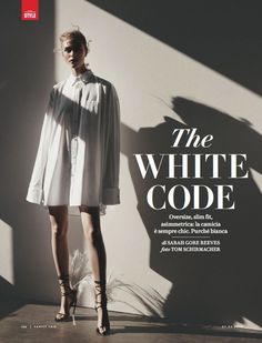 a woman standing in front of a white wall with the words the white code on it