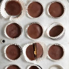 chocolate cupcakes are lined up on a baking sheet and ready to be eaten