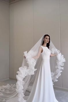 a woman in a white wedding dress and veil