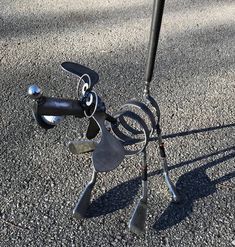 a metal sculpture sitting on top of a sidewalk