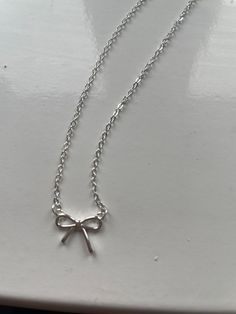 A beautiful bow necklace on an 41cm fine curb sterling silver chain very cute and dainty necklace bow 1cm x 1cm Cute Jewelry Necklaces Silver, Cheap Silver Necklaces, Dainty Silver Necklaces, Jewellery Silver Necklace, Cute Silver Necklace, Dainty Charm Necklaces For Party, Dainty Sterling Silver Necklace For Party, Silver Delicate Chain Charm Necklace For Party, Silver Charm Necklace With Delicate Chain For Party