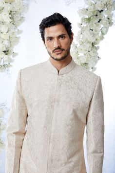 This sherwani set features all over matt sequin on a sand raw silk base. It is paired with off-white silk kurta and soften raw silk afghani salwar. Complimenting stole and footwear is also available.From Seema Gujral's Tuscan Summer collection. DELIVERY TIMEPlease allow 8-12 weeks for your outfit to arrive.FABRIC DETAILSRaw SilkProfessional cleaning only. Off White Bandhgala With Naqshi For Festive Occasions, Off White Naqshi Bandhgala For Festive Occasions, Off White Naqshi Sherwani For Diwali, Festive Off White Bandhgala With Naqshi, Off White Bandhgala With Naqshi For Diwali, Off White Naqshi Bandhgala For Diwali, Elegant Beige Raw Silk Churidar, Bollywood Style Off White Bandhgala With Naqshi, Cream Kurta With Naqshi In Traditional Drape