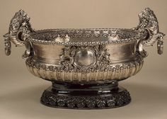 an ornate silver bowl on a pedestal