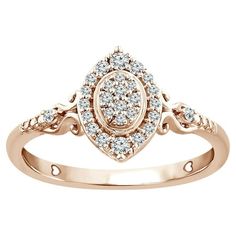 a rose gold ring with diamonds in the center and an intricate design on the band