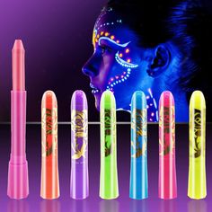 a woman with neon makeup and face paint on her face is next to seven fluorescent colored lip glosses