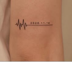 a woman's arm with a heartbeat tattoo on the left side of her body