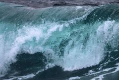 a man riding a wave on top of a surfboard