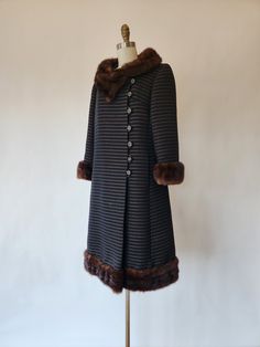 This vintage 1960s black and brown wool and mink trimmed collar and cuff coat is wonderful! The coat features pockets and double breasted front button closures.  ✂------ M E A S U R E M E N T S ------- best fit: medium - large coat bust: 36 inches waist: 38 inches hips: 42 inches sleeves 20 inches length: 41 inches tag/label: Union Made AFL-CIO / 840653 National Board Coat and Suit Industry  material: wool (blend) and mink condition: near very good vintage condition. There is what appears to be a small mouth bite at the bottom right side of the coat; see photo.  ★ Free Shipping - Processing, packaging and tracking are included for most U.S. order and there may be an additional cost for international orders. ★ Express shipping is available for the U.S. & international orders for an addition Coat And Suit, Union Made, Vintage Coat, Suits Coats, Fashion Story, Womens Jackets, Collar And Cuff, Vintage 1960s, Double Breasted