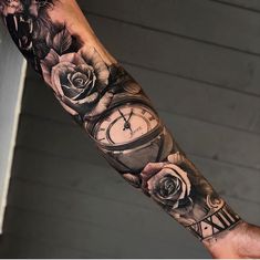 a man's arm with roses and a clock on the inside of his arm