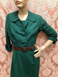 "Late 1950s Deadstock without Tags Emerald Green Wool Jersey Suit by \"Style Vogues Original, the Treasure Chest of Fashion\". Wiggle Dress with Matching Cropped Bolero Jacket with Cuffed 3/4-Length Sleeves. Rear Metal Zipper, The Skirt of the dress and the jacket are lined in rayon sateen sharkskin (both exhibit intermittent fade). Outstanding condition, no moth holes, no stains, no detractions. Measures Chest-32-Snug 33\", Waist-23\", Hip-36-Snug 38\", Length shoulder to hem-40\". Belt shown i Retro Fitted Lined Outerwear, Retro Fall Dresses For Vintage Events, Retro Dresses For Vintage Events In Fall, Fitted Vintage Lined Outerwear, Fitted Retro Outerwear With Buttons, Retro Fitted Outerwear With Buttons, Fitted Lined Vintage Outerwear, Fitted Vintage Outerwear, Green Fitted Retro Outerwear