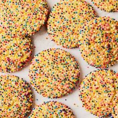 sprinkle covered cookies on a white surface