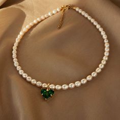 This elegant necklace made of natural pearls will be a beautiful accent to your look. The pendant with a deep green crystal looks unique in combination with the classic pearls. Choose this choker and look stunning. Materials: Natural freshwater pearls. Heart pendant: cubic zirconia and brass. Pendant size: 1,4cm*1,4cm. Fittings: brass. Length 40см (+5cm). 🔸more from us🔸 https://www.etsy.com/shop/DoraJewelryAccessory Green Stone Pendant, Romantic Woman, Jewelry Accessories Ideas, Elegant Necklaces, Green Stone, Green Crystals, Natural Pearls, Stone Pendants, Heart Pendant