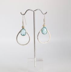 These earrings are a perfect combination of gold and light blue. The gold hoops are delicate and understated, while the light blue stones add just the right amount of color. They're a great accessory for any outfit. Light Blue Metal Earrings As A Gift, Light Blue Metal Earrings For Gift, Blue Nickel-free Earrings, Nickel Free Blue Earrings, Blue Nickel-free Hoop Earrings For Party, Nickel-free Blue Teardrop Earrings For Party, Blue Nickel-free Teardrop Earrings For Party, Light Blue Dangle Earrings For Pierced Ears, Elegant Light Blue Nickel-free Earrings