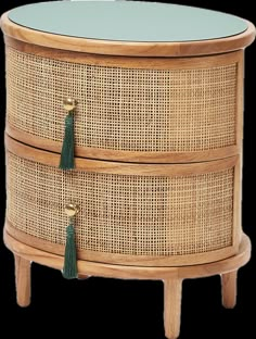 a round wicker table with two drawers and tassels on the bottom shelf