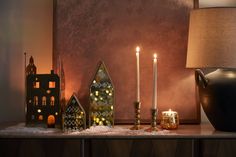 a table topped with candles and christmas decorations