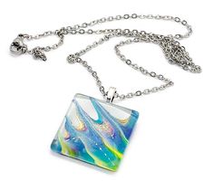 Stainless steel 17.5" chain necklace with lobster clasp closure. Glass domed pendant has been hand painted and measures 1" square with iridescent qualities to it Square Metal Necklace For Gift, Square Metal Necklaces For Gifts, Iridescent Metal Necklace Gift, Multicolor Square Jewelry Gift, Multicolor Square Jewelry For Gifts, Iridescent Glass Necklaces As Gifts, Iridescent Necklace With Adjustable Chain For Gift, Iridescent Jewelry With Adjustable Chain For Gift, Hand Painted Rectangular Jewelry As Gift