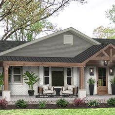 a house with two chairs on the front porch and potted plants in pots next to it