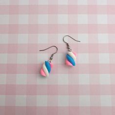 These earrings look just like the flump marshmallows but in trans pride colours! They're a super fun and subtle way of showing your trans pride! We're big on supporting the LGBTQ+ community at Candy Goblins, so we're donating all the profits from the sale of these earrings. The money from the profits will be going towards Trans Aid Cymru. They're dedicated to helping the trans community in Wales! They use their funds to help trans people who are struggling with rent, food, cost of medication and gender-affirming clothes. You can learn more about them at their website here: https://transaid.cymru/ All of our hooks are silver-plated, but we also do 925 sterling silver hooks, clip-ons, and clasp hooks for stretched ears for free on request. All you need to do is leave a note when checking out Pride Colours, Transgender Flag, Candy Earrings, Trans Community, Food Cost, Trans People, Quirky Jewelry, Pride Colors, Trans Pride