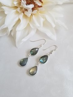 Labradorite Earrings, Labradorite Dangle Earrings, Crystal Drop Earrings, Statement Earrings, Gift for Her, Gemstone Earrings Make a statement in these gorgeous natural dangle Labradorite Earrings! Faceted bezel set teardrops create these stunning teardrop earrings that will soon become your favorite. These stones have beautiful flashes of blues and greens. Each stone is natural so no two are exactly the same. Earrings measure about 2 inches. Stones are about 16mm. Ear wires are genuine Sterling Nickel-free Labradorite Drop Earrings, Handmade Long Drop Labradorite Earrings, Gift Labradorite Earrings, Handmade Labradorite Teardrop Earrings, Labradorite Teardrop Earrings As Gift, Labradorite Teardrop Earrings For Gift, Magical Stones, Labradorite Earrings, Earrings Crystal