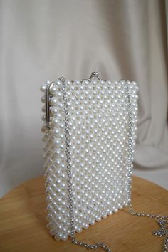 You can find our bags on Etsy.com Elegant White Bags With Pearl Chain, Pearl White Pearl Evening Bag For Events, White Evening Bag With Pearl Chain, White Pearl Clutch For Events, Rectangular Pearl Evening Bag With Pearl Embroidery, Handmade Pearl White Evening Bag For Events, Evening Bags With Pearl Chain, Rectangular Pearl White Pearl Clutch, White Bags With Pearl Chain