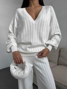 "White knitted pantsuit with a knitted pattern is stylish and cozy!  The set is knitted from a natural blend of cotton and viscose yarn and consists of a deep V neck sweater and straight fit pants, pleasant to the body and to the touch.  The suit can be worn anywhere as a casual outfit for every day, walking, traveling or a cozy home look.   DETAILS  - white  - 80% cotton, 20% viscose  - knitted pattern  - loose fit  - deep V neck - straight fit pants   SIZES   This suit is available in 3 sizes XS-S,  M-L and XL-XXL  Dropped sleeve 31.5\"/ 80 cm  Back length 25.6\"/ 65 cm  Pants length 42.9\"/ 109 cm  Inseam 30.7\"/ 78 cm Size  XS - S  bust 84-88cm = 33.08-34.64 inches,  waist 63-67cm = 24.8 - 26.37 inches  hips 92-96 = 36.22-37.80 inches.   M-L BUST 36-37.7 inches / 92-96 cm WAIST 28-29.5 Winter Knit Long Sleeve Sets, Winter Long Sleeve Knit Sets, Stretch Knit Sweater For Loungewear, Pointelle Knit Sweater For Loungewear In Fall, Fall Pointelle Knit Sweater For Loungewear, Cable Knit Sweater For Loungewear, Textured Knit Sweater For Loungewear, V-neck Knitted Sweater For Loungewear, Knitted V-neck Sweater For Loungewear