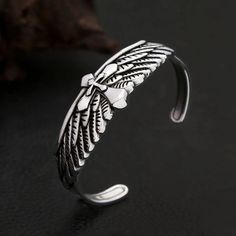 Vintage Fashion Stainless Steel Eagle Wings Bracelet Discover the perfect accessory for expressing your unique style with our Vintage Fashion Stainless Steel Eagle Wings Bracelet. This trendy charm bracelet is designed for both men and women, making it a versatile addition to any jewelry collection. Specifications Gender: Unisex Metals Type: Stainless Steel Fine or Fashion: Fashion Style: Punk Material: Metal Shape/Pattern: Cross Detail Packing: Jewelry Bag Metal: 316L Stainless Steel Durability Trendy Metal Wristband As Gift, Adjustable Stainless Steel Punk Bracelets, Punk Style Bangle Bracelets As Gifts, Punk Style Bangle Bracelets For Gifts, Handmade Adjustable Alloy Bracelets, Punk Style Metal Bracelet For Gift, Handmade Punk Style Bracelets As Gift, Adjustable Alloy Bangle Bracelet, Silver Punk Wristband As Gift