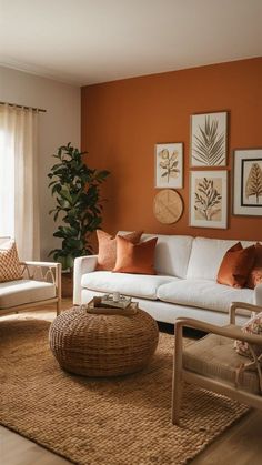 a living room with orange walls and white furniture