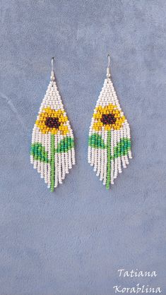 "These handmade unique earrings \"Sunflower\" are made of high-quality Czech beads and strong synthetic thread. I use my author's scheme . They are elegant, fashionable, and highly versatile, suitable for everyday wear. Color: white,yellow,brown,green . Copy without my permission is prohibited For those who want to buy my copyright scheme for these earrings: https://www.etsy.com/uk/listing/1056785837/brick-stitch-pattern-for-seed-bead?ref=shop_home_active_2 100% hand made with love! Measurements White Flower-shaped Jewelry With Sunflower Design, White Flower Jewelry With Sunflower Design, White Sunflower Design Flower Jewelry, White Dangle Flower Earrings With Colorful Beads, White Flower Dangle Earrings With Colorful Beads, Sunflower Dangle Earrings For Summer, Summer Sunflower Dangle Earrings, Summer Beaded Dangle Flower Earrings, White Flower Shaped Beaded Earrings With Colorful Beads