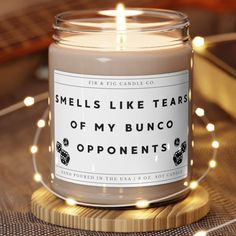 a candle that says smells like tears of my bunco oppenents on it