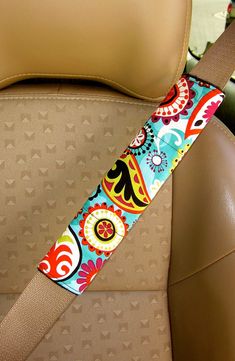 the seat belt is decorated with colorful flowers