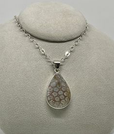 Charles Albert Designer Fossil Coral Teardrop Pendant set in Fine Sterling Silver ( .950 ). Lovely Gray and Red color Fossil Coral Teardrop Pendant is 1.9 x 1.2 inches around and hangs 2.5 inches from the top of the generous Fine Sterling Silver bail. This Teardrop Pendant is a double sided cabochon, nicely domed and open to the back of the pendant. All Handmade. Lovely swirling shades of Gray and Red with Fossil imprints throughout this Teardrop Pendant, and has a generous bail to accommodate c Silver Drop Necklace With Cabochon, Silver Teardrop Jewelry With Stone Setting, Silver Pear-shaped Cabochon Jewelry, Silver Pear-shaped Natural Stone Jewelry, Fossilized Coral, Pretty Pendant, Fossil Coral, Shades Of Gray, Cabochon Pendant