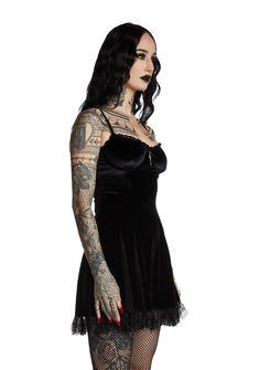 will have them under the illusion of devotion. You're like a prayer in this impure velvet mini dress that has sinful lace trim, underwire support, a deathly devoted cross design and back zip closure. Black Gothic Mini Dress With Lace Trim, Gothic Lace Trim Mini Dress For Halloween, Halloween Gothic Mini Dress With Lace Trim, Gothic Halloween Mini Dress With Lace Trim, Gothic Mini Dress With Lace Trim For Night Out, Black Velvet Gothic Mini Dress, Gothic Mini Dress With Corset Back, Fitted Gothic Velvet Dress For Costume Party, Fitted Gothic Velvet Mini Dress