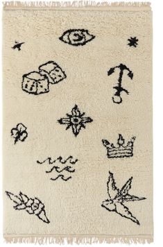 a white rug with black and white designs on it's sides, including an arrow