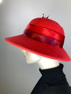 This hat would be right at home on Downton Abbey! The color is a bright red. It is topped with a hand dyed silk band that matches perfectly! Embellished with tree handmade silk roses and hand cut feathers. The brim shape is a soft oval and the sides are longer than the front; the back is much narrower at 2 1/4 inches. It is hand blocked using traditional millinery techniques, including steaming, shaping, and hand sewing. ++++++++++++++++++++++++++++++++++++++++++++++++++++++FIT AND SIZE:The inne Womens Winter Hats, London In March, Downton Abbey Style, Downton Abbey Fashion, Tree Handmade, Warm Winter Hats, Dyed Silk, Womens Winter, Hand Dyed Silk