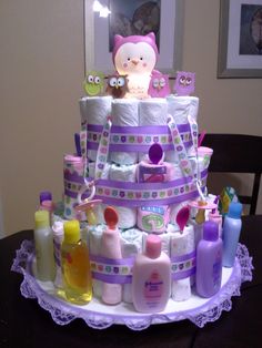 a cake made to look like a baby's diaper tower with lots of items on it