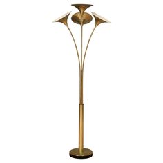 a brass colored floor lamp with three lamps on each side and one light in the middle