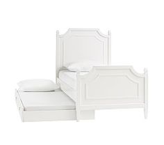 a white bed sitting next to a white dresser