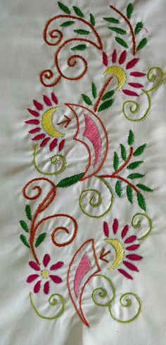 an embroidered design on a white sheet