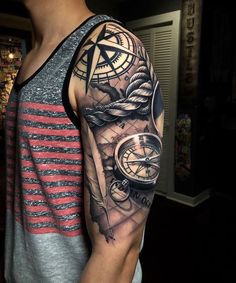 a man with a clock and compass tattoo on his arm