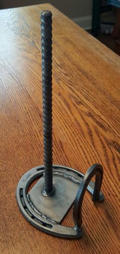 a metal object sitting on top of a wooden table