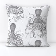 an octopus pillow is shown on a white surface with black and white images in the background