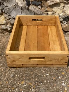 an empty wooden box sitting on the ground