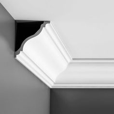 the corner of a white ceiling with black trim