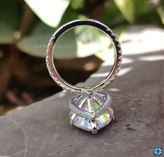 a diamond ring sitting on top of a rock