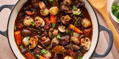 a pot filled with stew and vegetables on top of a table