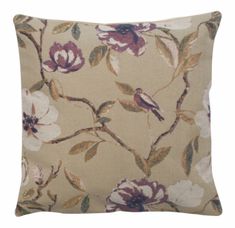 a pillow with flowers on it and a bird sitting on the branch in the middle