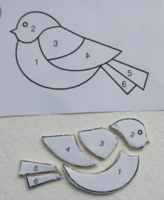 cut out pieces of paper to make a bird ornament with numbers on it