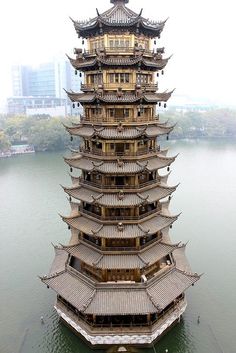 an elaborate building in the middle of water