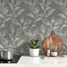 the wallpaper in this kitchen is designed to look like leaves