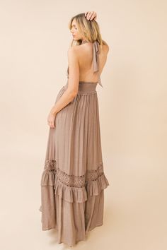 A solid woven maxi dress featuring halter neckline, smocked waist band and lace inset with ruffled hemline Details Self: 65% Polyester, 35% Rayon Contrast: 100% Cotton Lining: 100% Polyester Size & Fit - Model is 5`8" And Wearing Size Small - Measurements Taken From Size Small - Approx. Length: 46" Elegant Beige Boho Maxi Dress, Flowy Boho Maxi Dress With Ruffles, Fitted Maxi Sundress With Lace Trim, Chic Maxi Length Dress With Lace Trim, Sleeveless Ruffled Maxi Dress For Festivals, Bohemian Flowy Midi Dress With Smocked Back, Spring Festival Ruffled Maxi Dress, Ruffled Spring Festival Maxi Dress, Maxi Length Ruffled Dresses For Festival